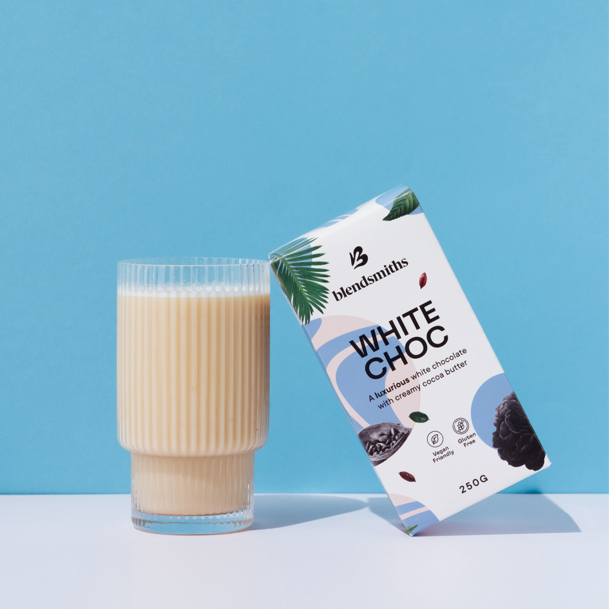 Blendsmiths iced white chocolate latte alongside packaging for the vegan drinking chocolate blend