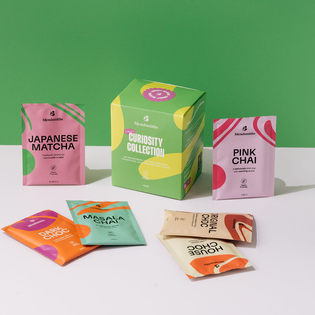 Blendsmiths Curiosity Collection box surrounded by colourful single-serve sachets showcasing a variety of flavours and bright, vibrant packaging
