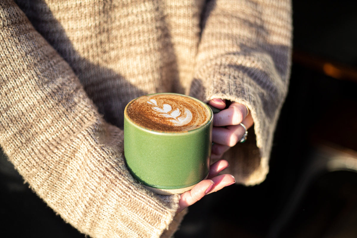 Person holding a cup of Blendsmiths chai latte