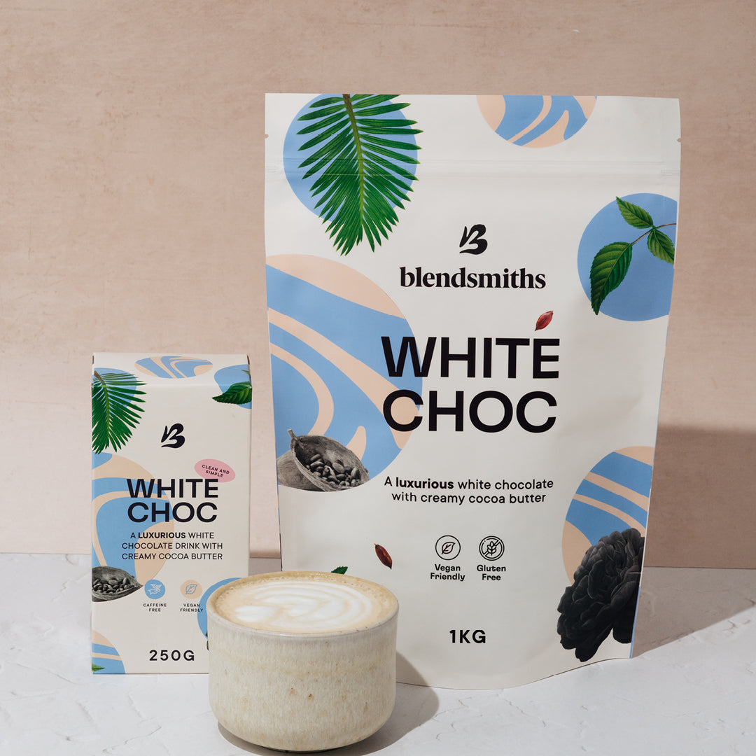 Blendsmiths White Chocolate blend in 250g and 1kg packs with a prepared white hot chocolate in the foreground