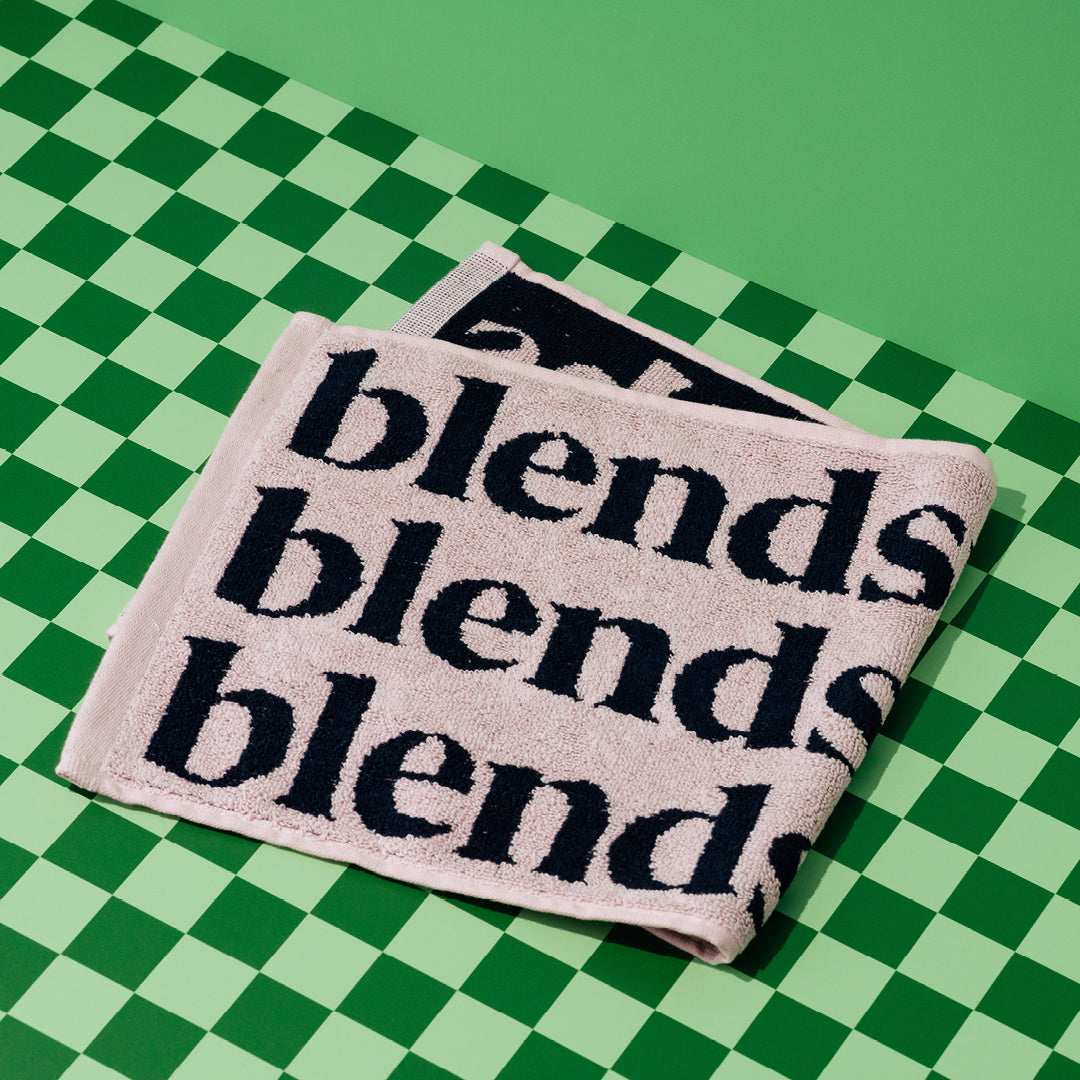 Pink Blendsmiths barista towel with navy Blendsmiths wordmark.