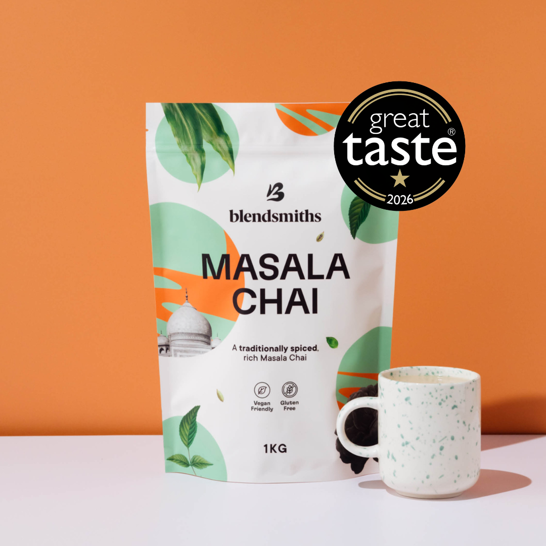 Blendsmiths 1kg Masala Chai packaging, Next to a Chair latte - showcasing the products Great Taste Award badge.